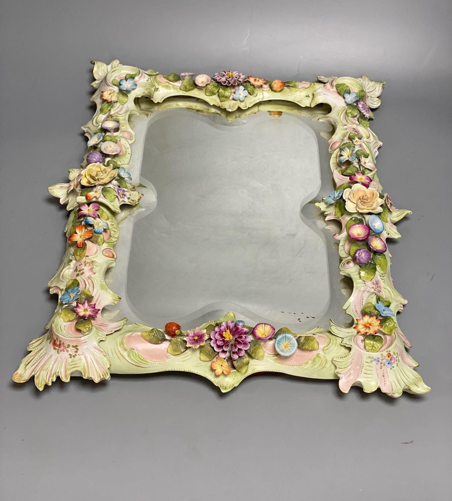 A porcelain floral encrusted wall mirror, German, Von Schierholz, 30 x 40cm